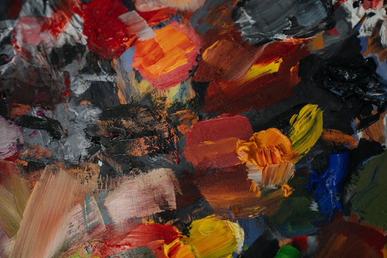 Colorful abstract oil paint texture with dynamic brush strokes and vivid hues.